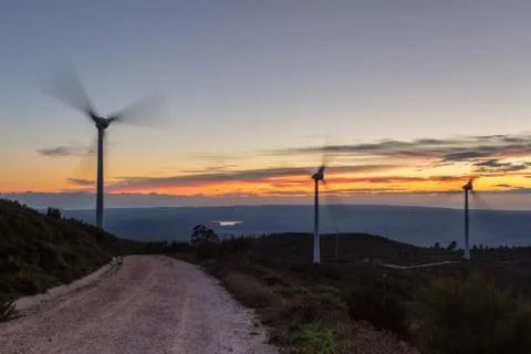 Magic sunset on the road with wind generators for electricity. Foto stock