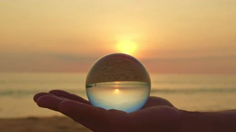 Magic sunset view in a crystal ball on your hand. Stock Footage 153556114