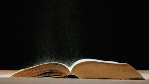 Magic vintage book of knowledge on black background slow motion. Stock Footage 265474410
