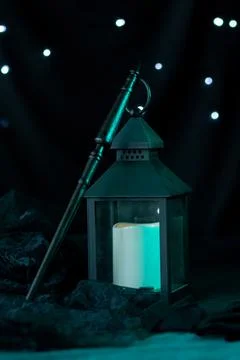 The magic wand stands leaning on the lantern Stock Photos