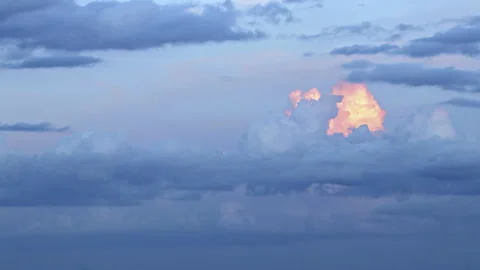 Magical blue and orange clouds swirl over the mountain at sunset. Timelapse Stock Footage 162799708