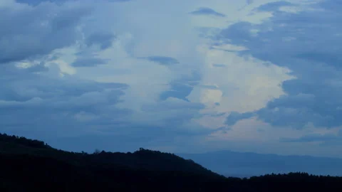 Magical blue clouds swirl over the mountain at sunset. Timelapse, relaxation Stock Footage 163029784