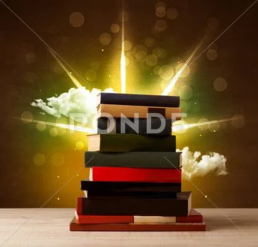Magical books with ray of magical lights and colorful clouds Stock Photos