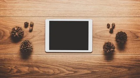 Magical christmas theme background, pine cones and digital tablet on w Stock Photos
