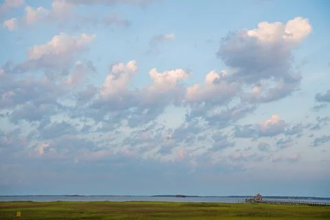 Magical cloudscape over marsh grass in Charleston, SC. Stock Photos