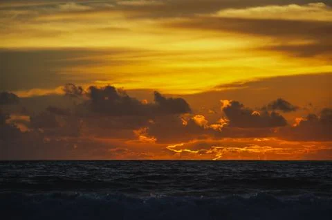Magical dramatic sunset on a tropical beach. Stock Photos