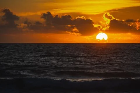 Magical dramatic sunset on a tropical beach. Stock Photos