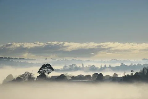 Magical misty village scene on a bright sunny morning Stock Photos