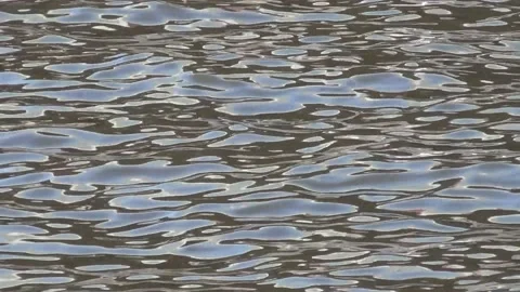 A magical picture created by the waves of the evening river Stock Footage 136673490