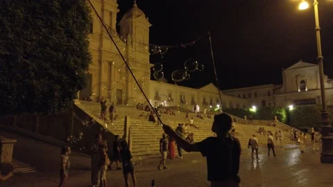 Magical soap bubbles games in Noto in the evening Stock Footage 204885193
