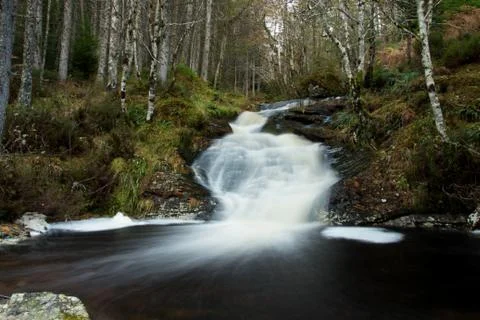 A magical stream pours down the mountain Stock Photos