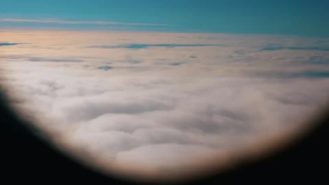 Magical view of snow-white clouds and blue sky from airplane window. Slow motion Vidéo 307286959