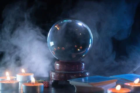 Magician or fortune teller is predicting future with crystal sphere. Stock Photos