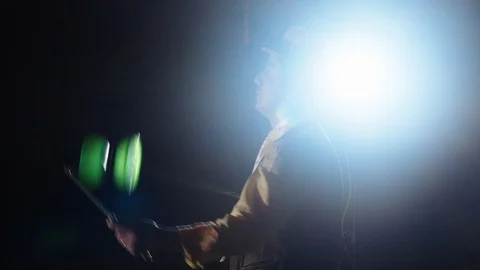 Magician performs a complicated circus trick using props outdoors during a Stock Footage 113938436