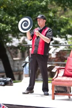 Magician performs visual illusion at spring festival Stock Photos