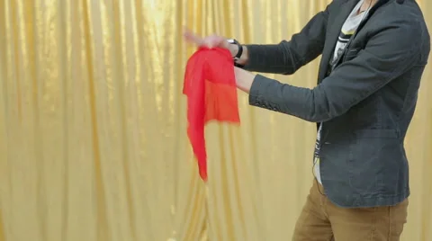 Magician shows tricks with red cloth Stock Footage 44751799