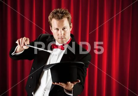 Magician: Waving Wand Over Hat Stock Photos