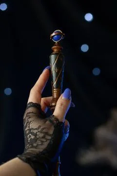 The magician's hand holds a magic elder wand Stock Photos