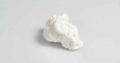 Magnesite on a white background. It is used in industry, lithotherapy, jewelry. Stockbeeldmateriaal 163507448