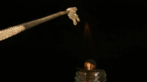 Magnesium is combusted to form a white oxide. 4K video Stock Footage 49835474