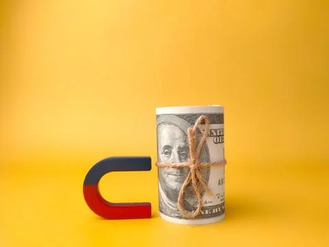 Magnet and banknotes on yellow background Stock Photos