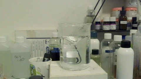 A magnet inside a test tube creating a vortex. Stock Footage 106938679