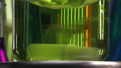 Magnetic agitator at work with yellow liquid beaker Stock-Footage 64292483