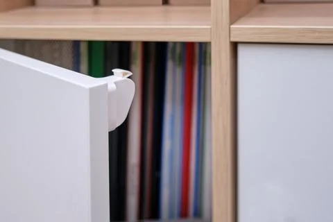 Magnetic child-proof lock for locking cabinet doors and drawers of home furni Stock Photos