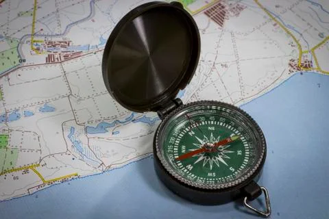Magnetic compass on the map Stock Photos