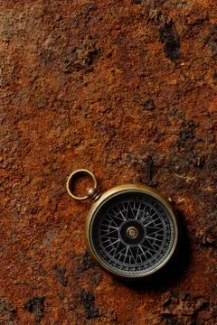 Magnetic compass on rough rusty background Stock Photos
