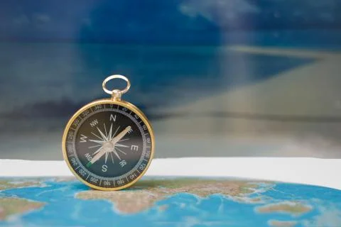Magnetic compass on world map, concept of travel and destination, macro trave Fotos de archivo