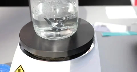 Magnetic mixer with fast moving stir bar for mixing liquid at medical factory Stock Footage 182396691