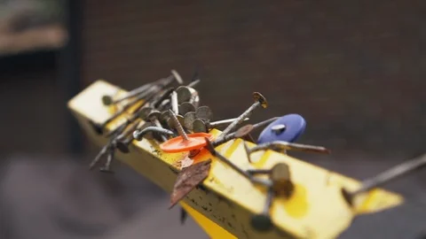 Magnetic nail collector with sharp tacks and debris at construction site Stock Footage 105249018