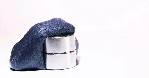 Magnetic Putty swallows a magnet in 4K | Science experiment in magnetism Stock Footage 112460733