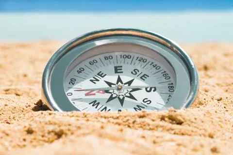 Magnetic Silver Compass On Sand Stock Photos