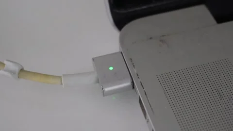 Magnetic wire cable power charge connect to laptop socket. Electricity Stock Footage 250313501