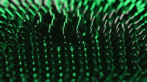 Magnetism and Green light over ferrofluid substances moved by a neodymium magnet Stock Footage 132899600