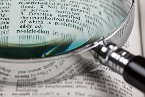 Magnifer and dictionary Stock Photos