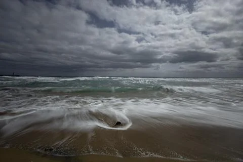 Magnificent clouds, powerful waves, and wide sea scenery Stock Photos
