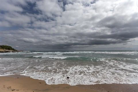 Magnificent clouds, powerful waves, and wide sea scenery Stock Photos