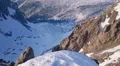 Magnificent horizontal pan of snowy mountain range, trees in beautiful valley 4k or 4k+ Resolution