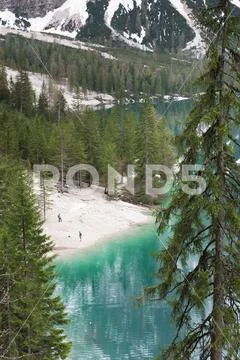 Magnificent lake Lago di Braies. The emerald smooth surface of water reflects Stock Photos