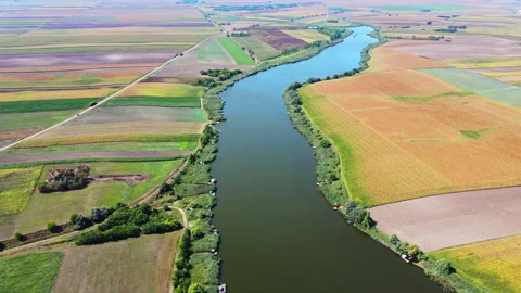 Magnificent look on the lake surrounded with multi colored fields from above Stock Footage 263091641