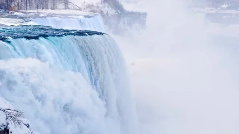 Magnificent Niagara Falls in winter. Streams of water fall down against the Stock Footage 86785579