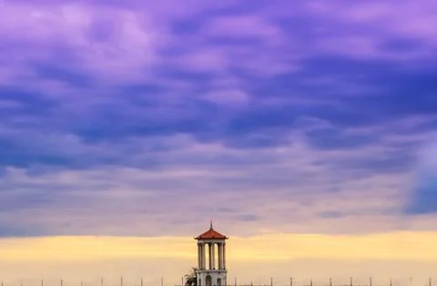 Magnificent sunset with dramatic thunderclouds. In the foreground is a tower Stock Photos