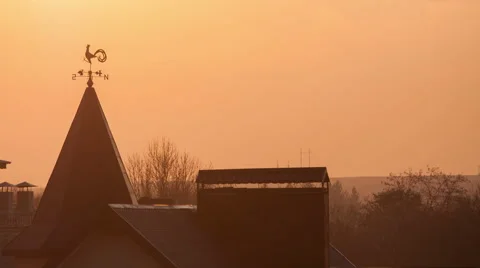 Magnificent sunset over the rooftops. wind indicator Stock Footage 48000680