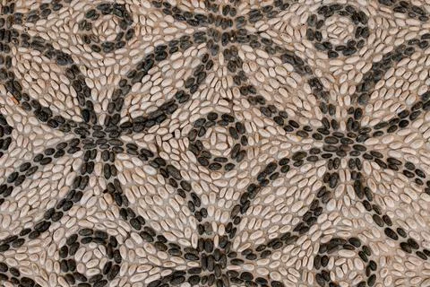 Magnificent top view of pattern lined with small white and black round pebbles Stock Photos