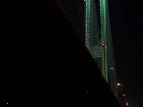 Magnificent view of the night bridge with glowing lights, passing vehicles Stock Footage 71864548