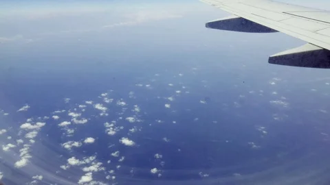 Magnificent view from the window of the plane. Endless blue sea aerial shot Stock Footage 73797781