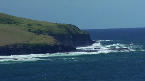 Magnificent Wide Angle Shot Large Waves Crashing Against Green Rocky Peninsula Stock Footage 314277495